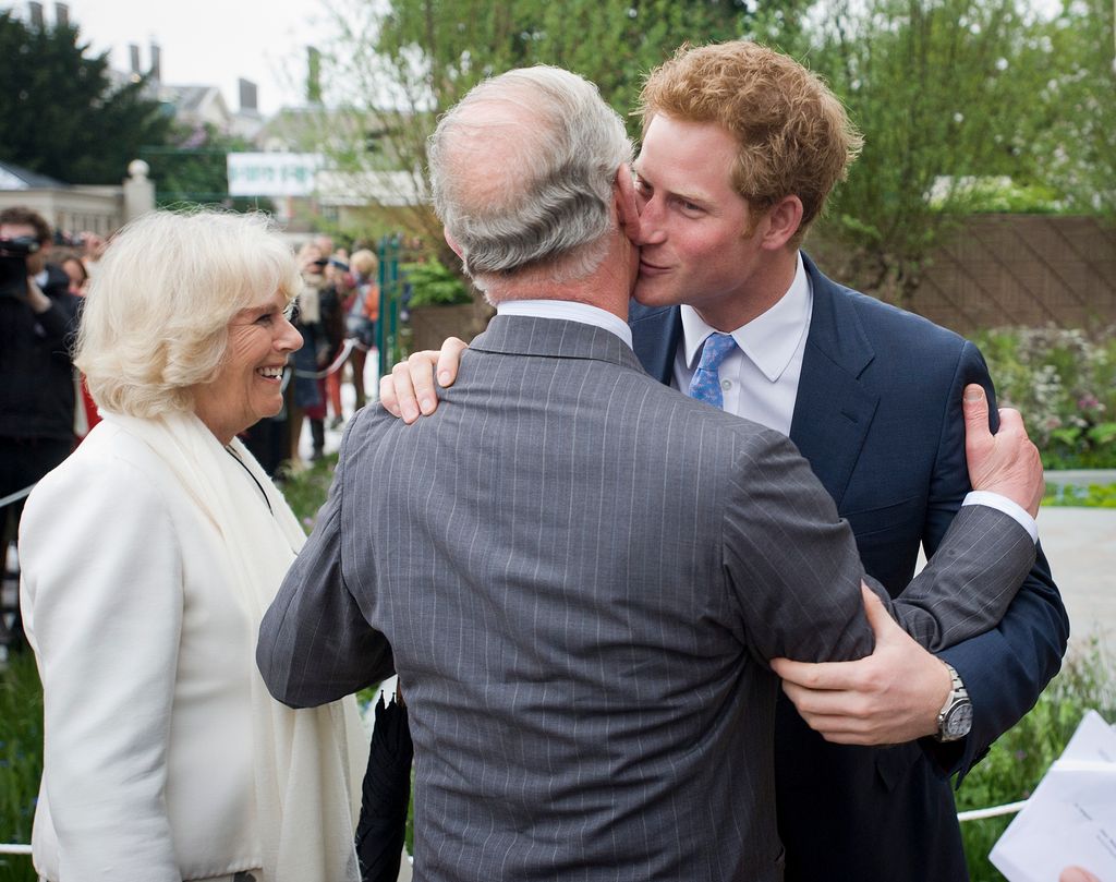 Prince Harry embraces his father Charles