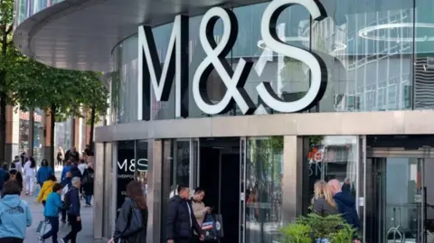 Getty Images M&S store front with people walking outside