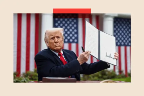 Bloomberg via Getty Images US President Donald Trump displays a signed executive order during a tariff announcement in the Rose Garden of the White House on 2 April 2025. 
