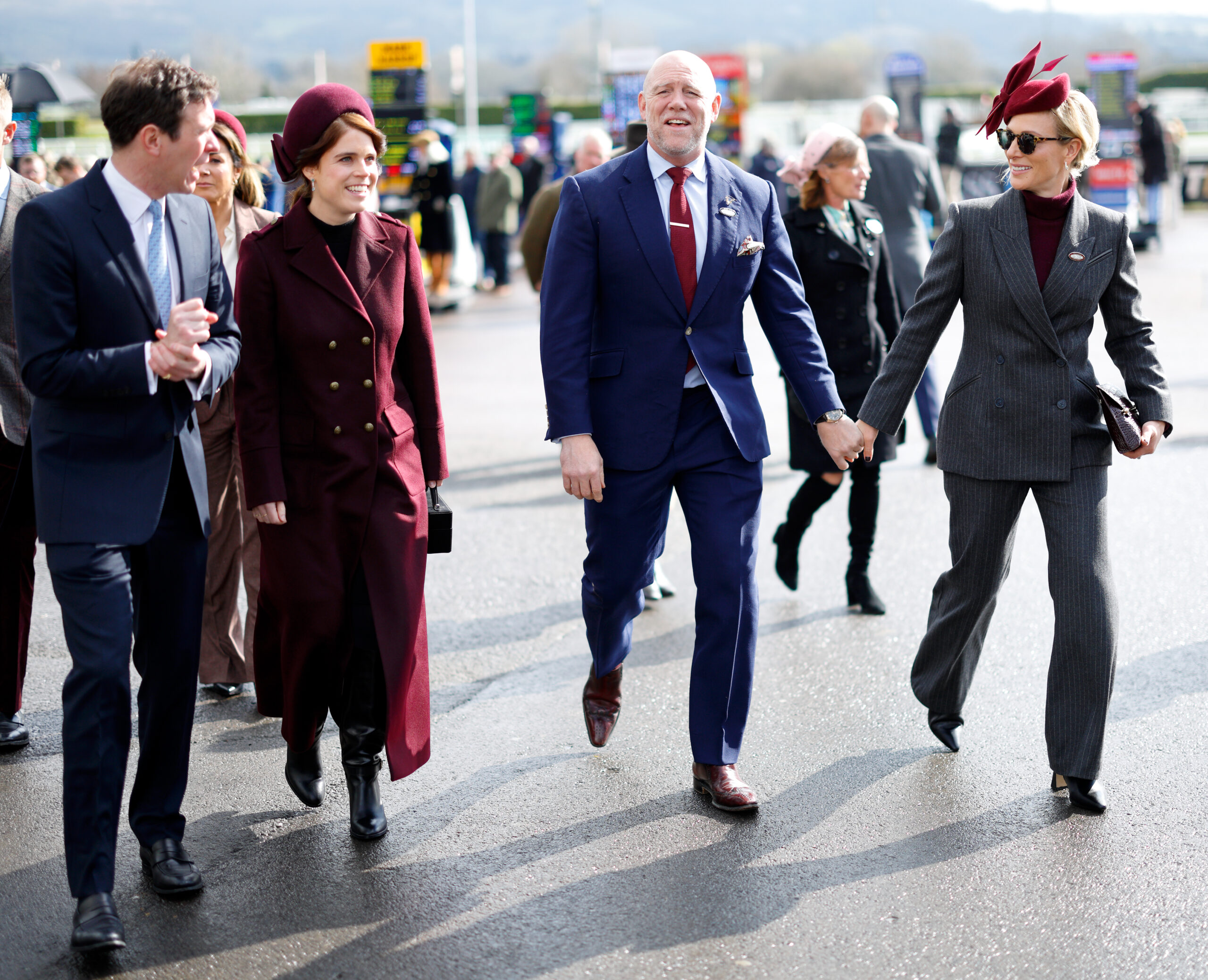 Zara and Mike Tindall holding hands walking next to Princess Eugenie and Jack Brooksbank