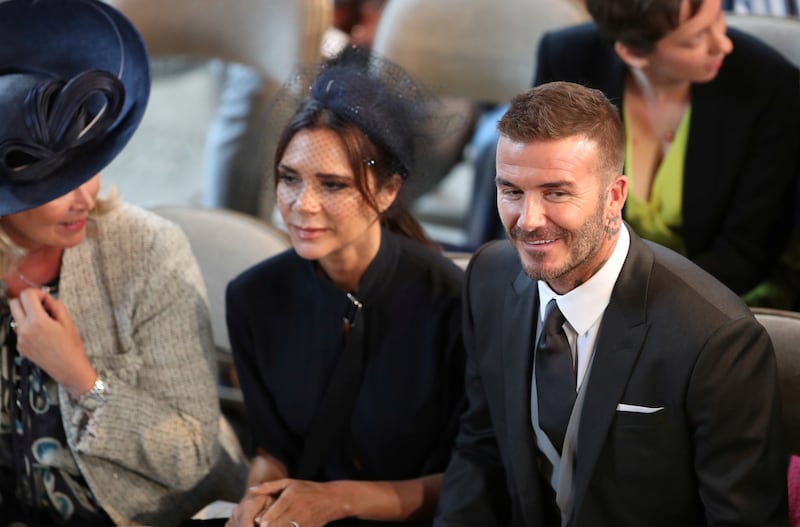 David and Victoria Beckham take their seats in St George's Chapel at Windsor Castle for the wedding of Prince Harry and Meghan Markle. Saturday May 19, 2018.  Danny Lawson/Pool via REUTERS
