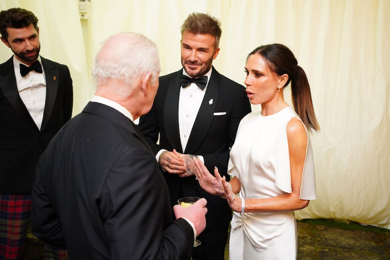 TETBURY, ENGLAND - FEBRUARY 07: King Charles III speaks to David Beckham and Victoria Beckham during a dinner in celebration of Slow Food at King Charles III's Gloucestershire estate, Highgrove Gardens on February 7, 2025 inTetbury, England. The King and Queen will join Hollywood star Stanley Tucci for a black tie dinner to celebrate Italian cuisine at Highgrove on Friday evening. The pair have invited the Italian-American Devil Wears Prada actor and well-known foodie and the Italian ambassador to the UK, Inigo Lambertini, to his  Gloucestershire estate to enjoy a feast of sustainable Slow Food. (Photo by Ben Birchall - WPA Pool/Getty Images)