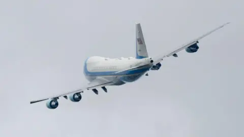 Getty Images A plane banking against a grey sky
