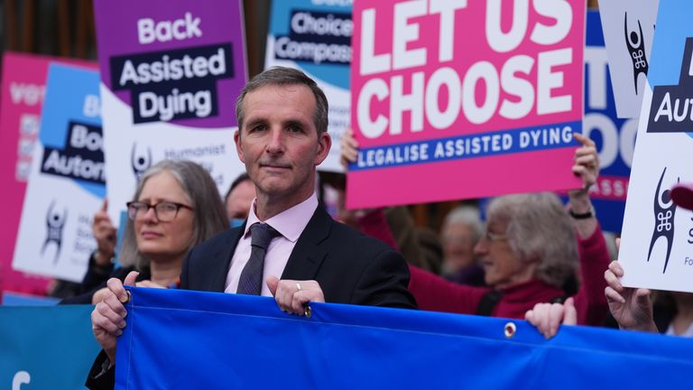 Liberal Democrat MSP Liam McArthur (centre) stands with supporters of a change in the law on assisted dying outside the Scottish Parliament in Edinburgh, ahead of the debate and vote on the Assisted Dying for Terminally Ill Adults (Scotland) Bill later today. Picture date: Tuesday May 13, 2025.