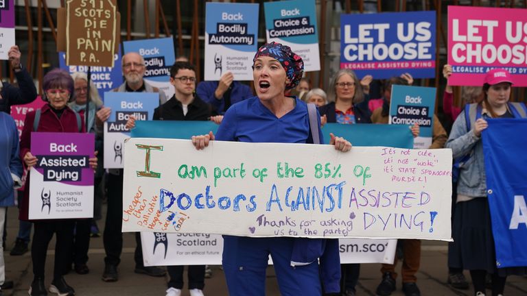 Doctor Geri Hignett protests against a change in the law on assisted dying, beside protesters demonstrating in support, outside the Scottish Parliament in Edinburgh, ahead of the debate and vote on the Assisted Dying for Terminally Ill Adults (Scotland) Bill later today. Picture date: Tuesday May 13, 2025.