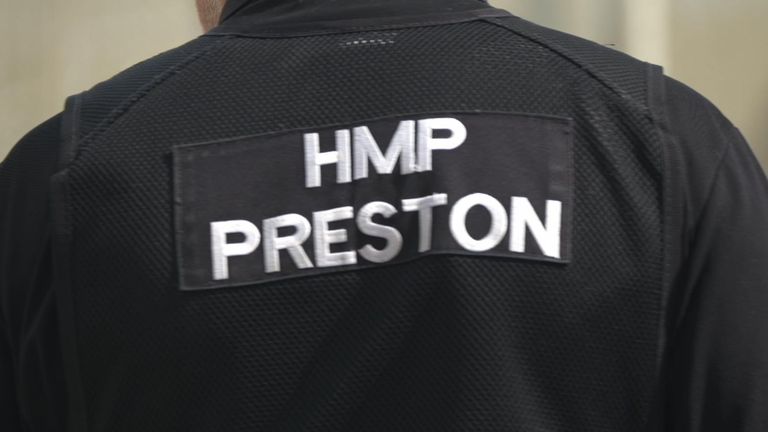 Inside Preston Prison, Sky News saw firsthand a system truly at breaking point - picture of a prison officer's back with HMP Preston written on it.