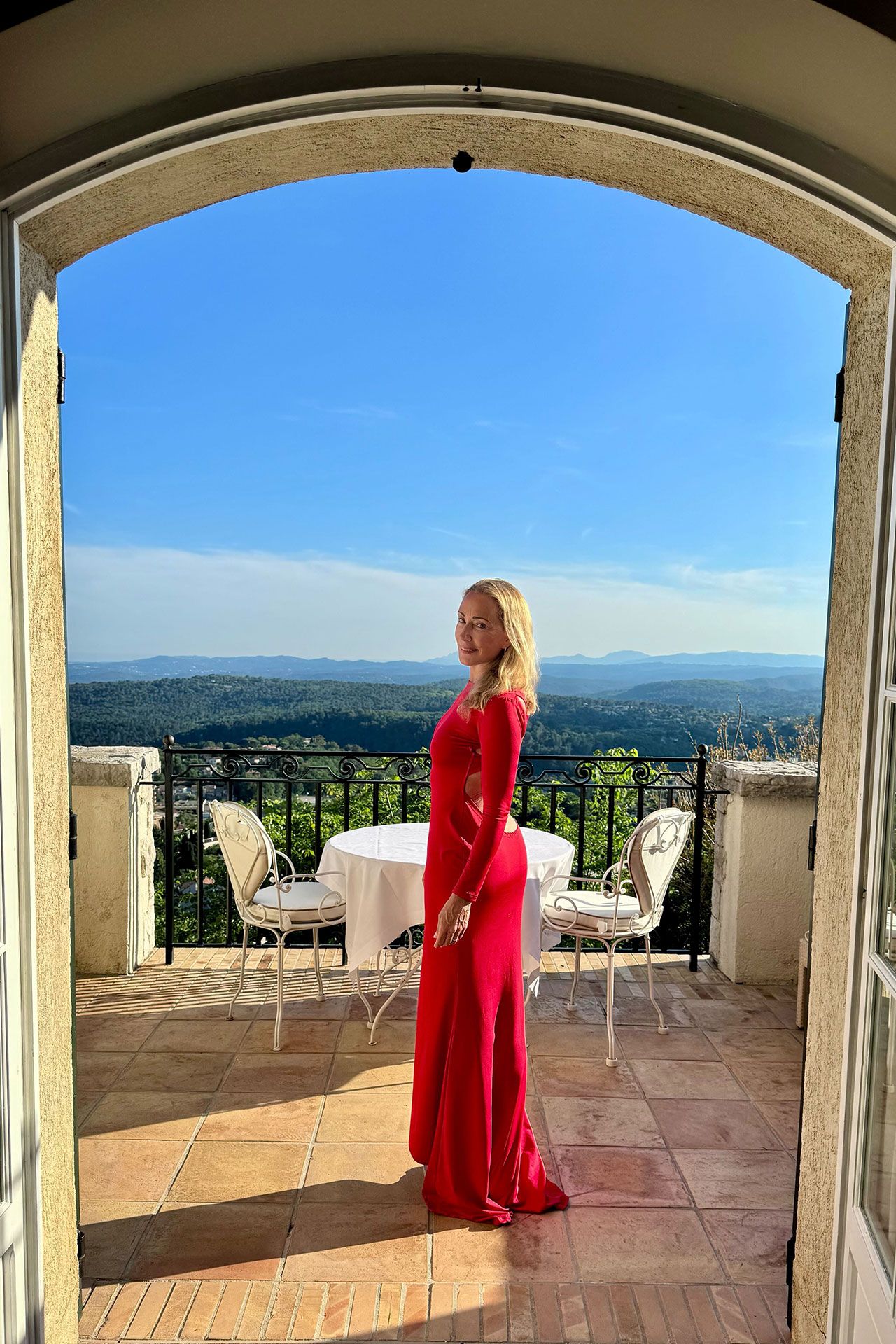 Image may contain Chair Furniture Desk Table Adult Person Clothing Dress Alcohol Beverage and Outdoors