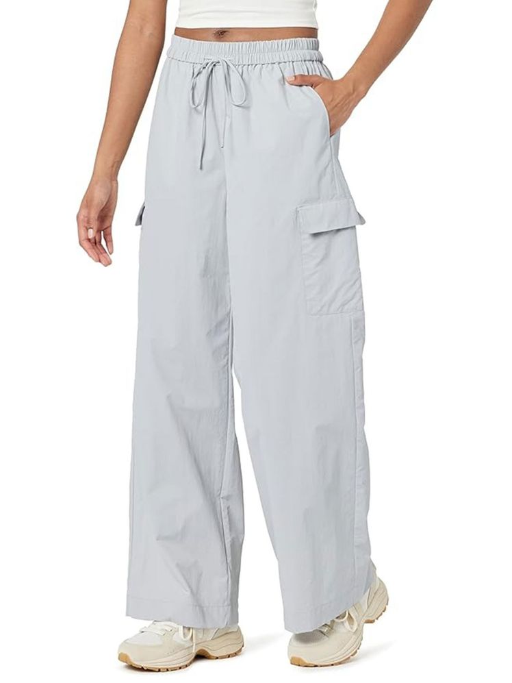 Image may contain: Clothing, Pants, Adult, Person, Home Decor, and Linen