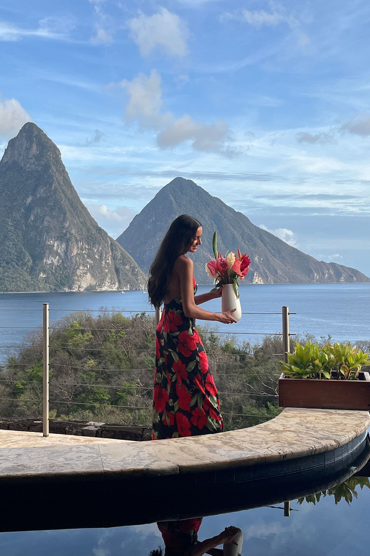 Image may contain Face Head Person Photography Portrait Plant Potted Plant Clothing Dress Water and Waterfront