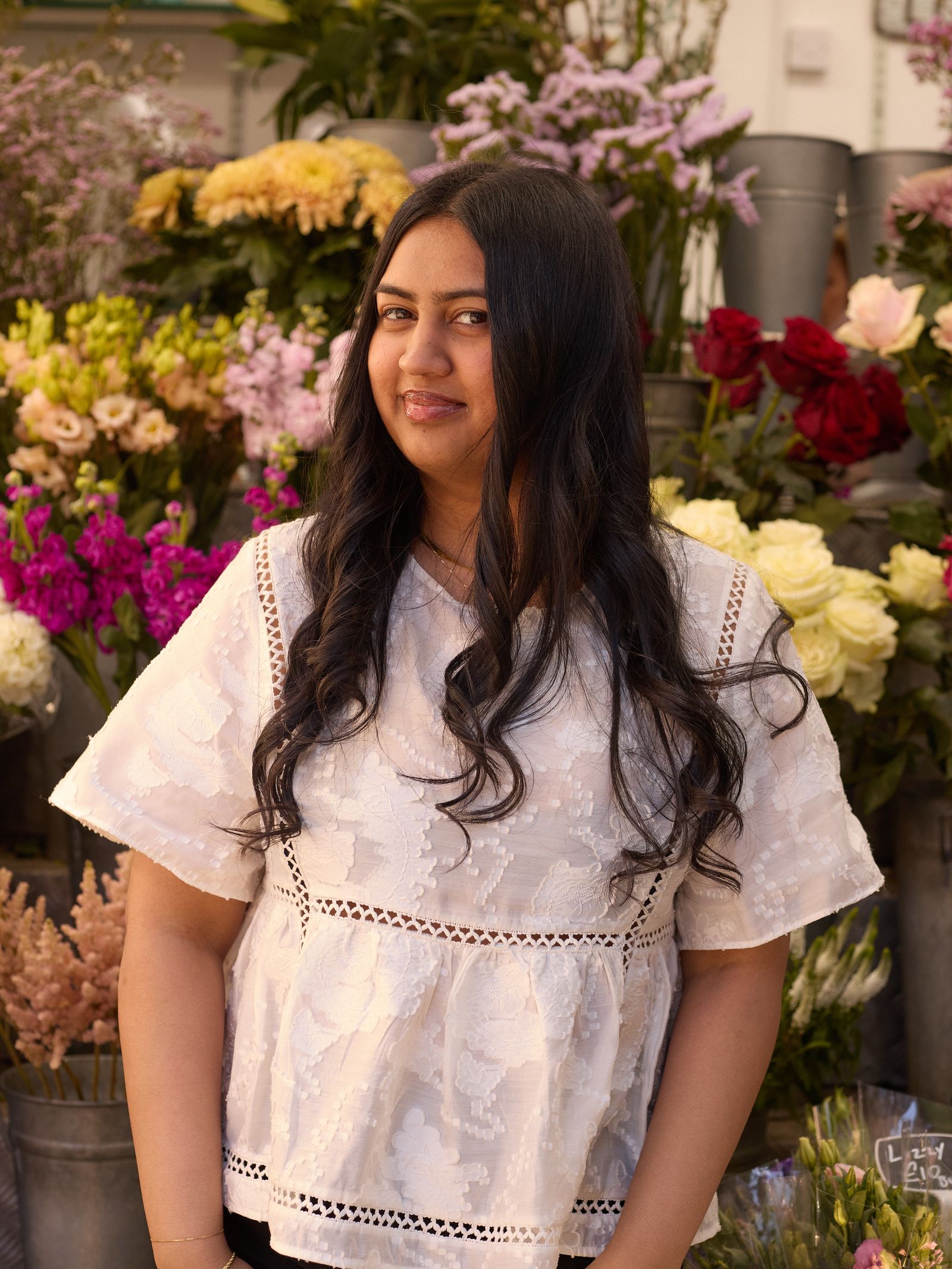 Image may contain Blouse Clothing Sleeve Accessories Bracelet Jewelry Adult Person Ring and Flower