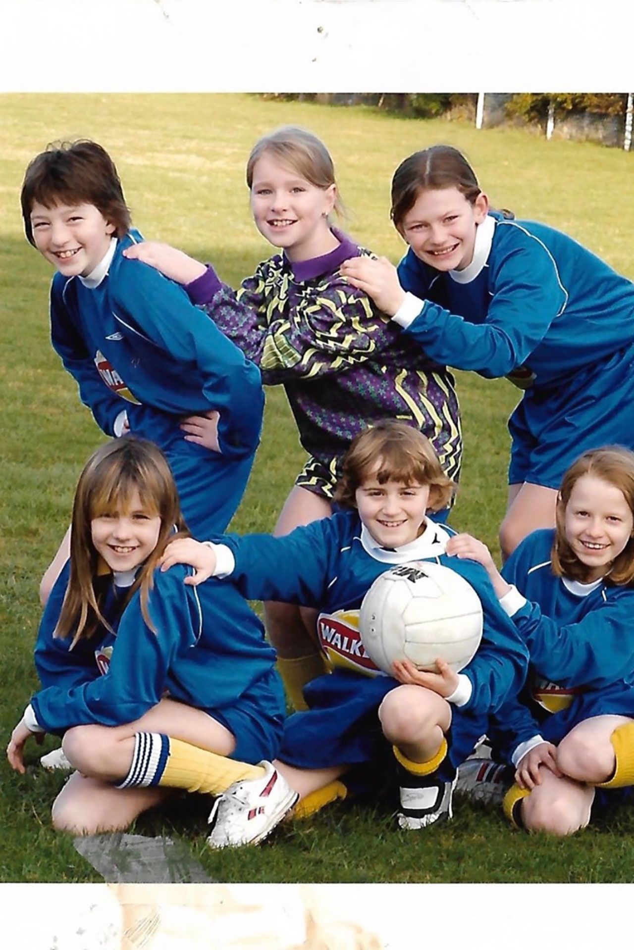 Image may contain Ball Football Soccer Soccer Ball Sport People Person Grass Plant Face Head and Photography