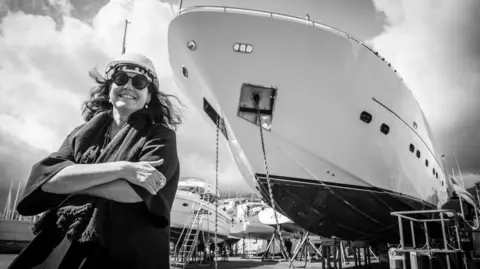 Barbara Armerio Italian shipbuilder Barbara Armerio smiles at the camera while crossing her arms, in front of a superyacht being built