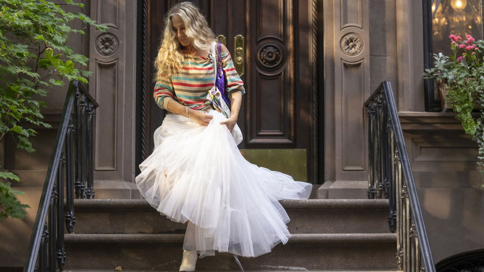 Image may contain Sarah Jessica Parker Clothing Dress Formal Wear Architecture Building House Housing and Staircase