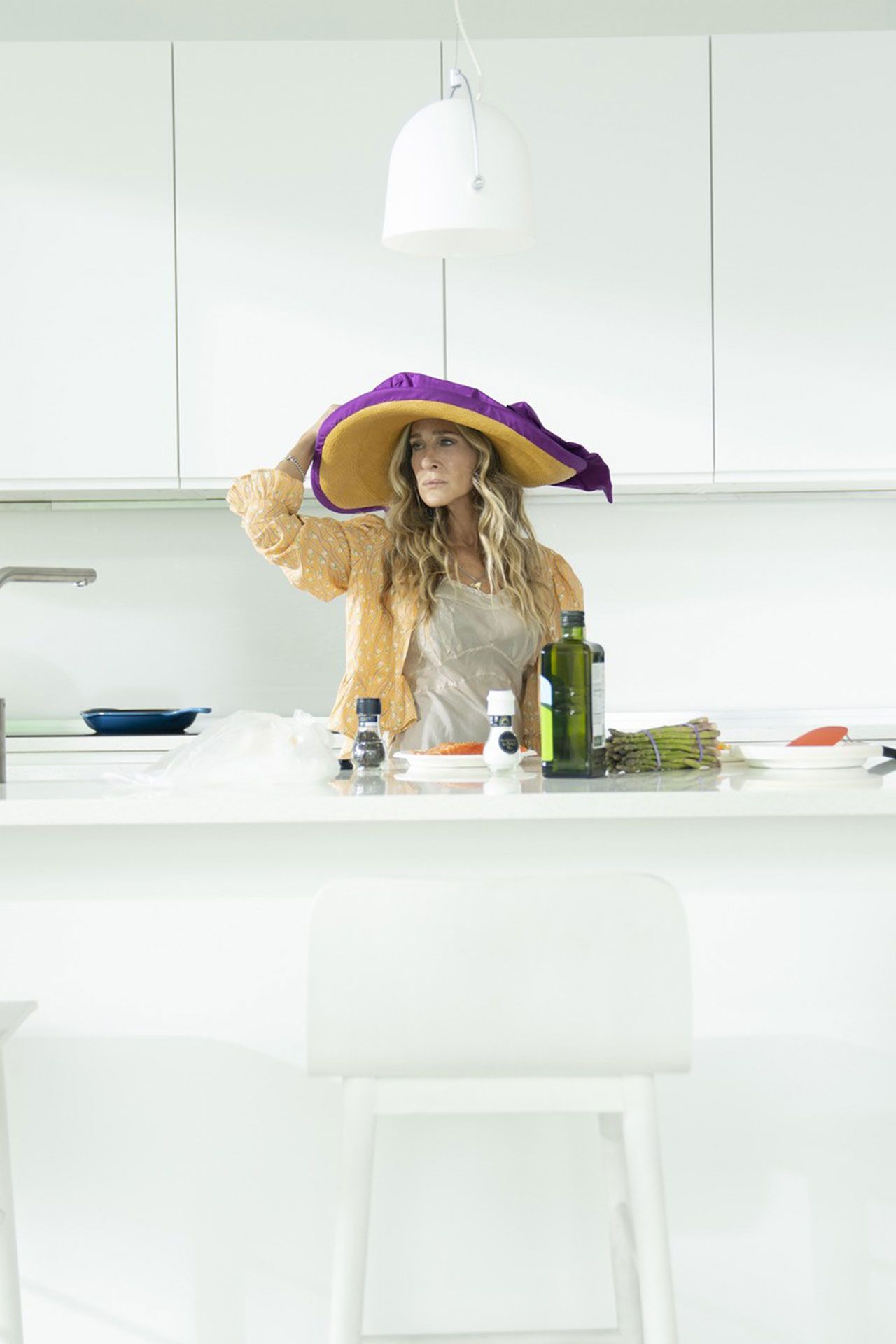 Image may contain Sarah Jessica Parker Clothing Hat Adult Person Lamp Furniture Table Chair and Accessories