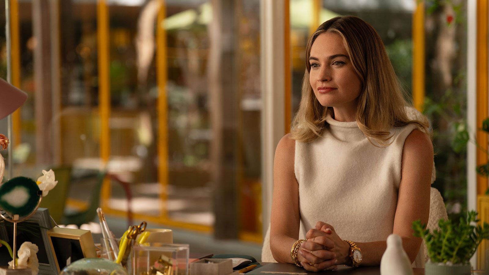 Image may contain Lily James Wristwatch Adult Person Plant Face Happy Head Smile Accessories Bracelet and Jewelry