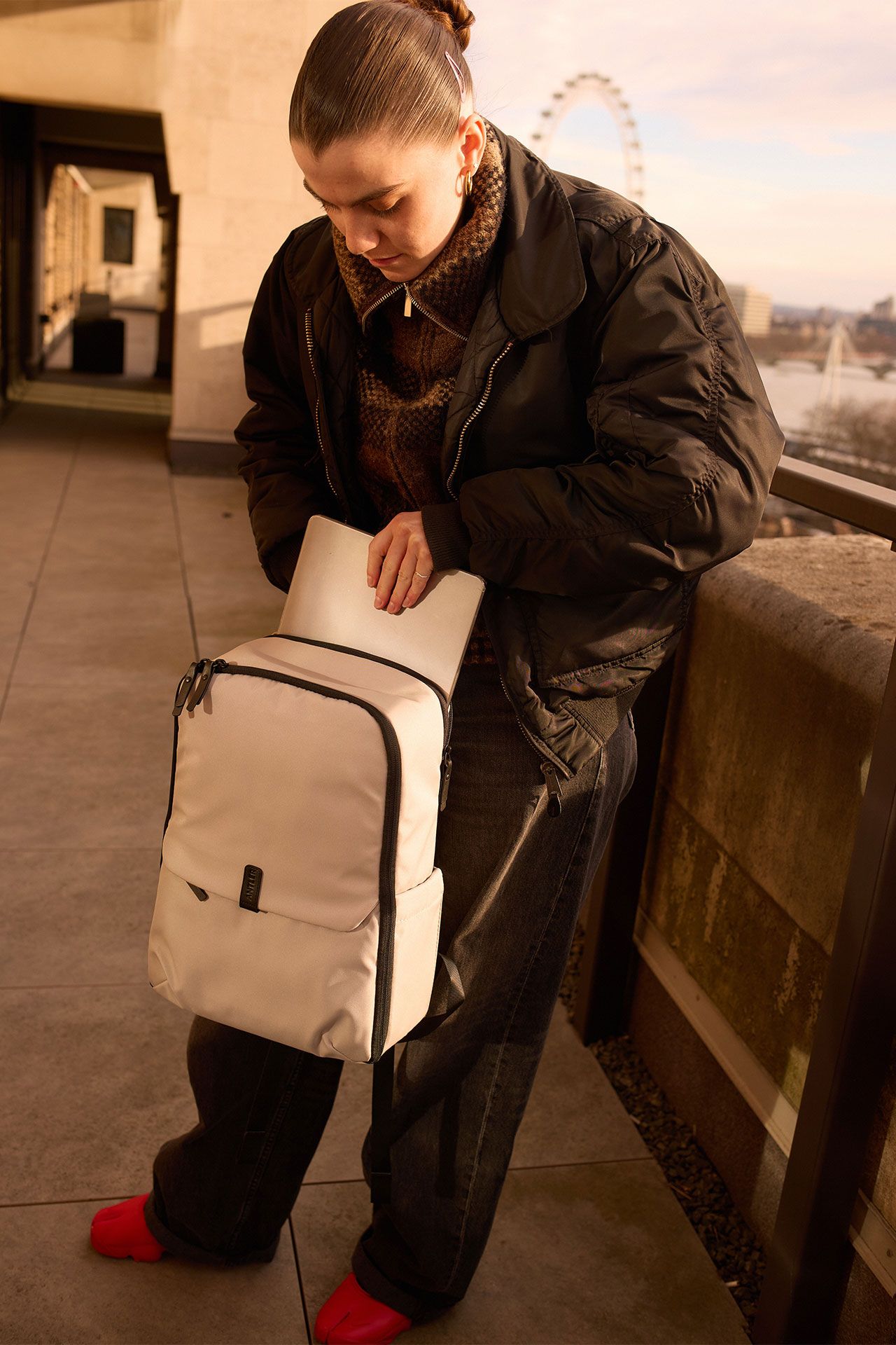 Image may contain Clothing Coat Pants Accessories Bag Handbag Jacket Person Footwear Shoe Photography and Face