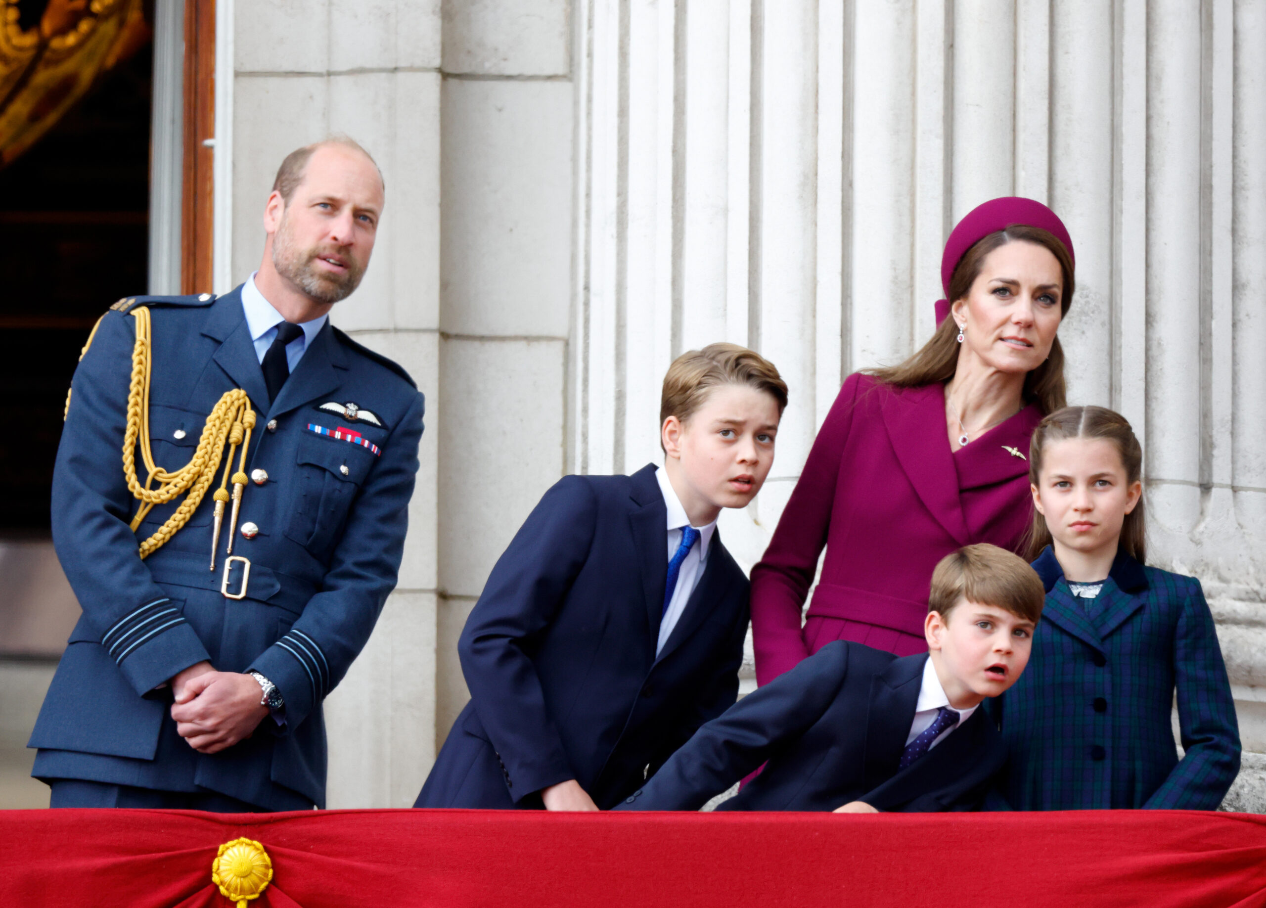 Prince William, Prince George, Princess Kate, Prince Louis and Princess Charlotte leaning to the side on the balcony at Buckingham Palace