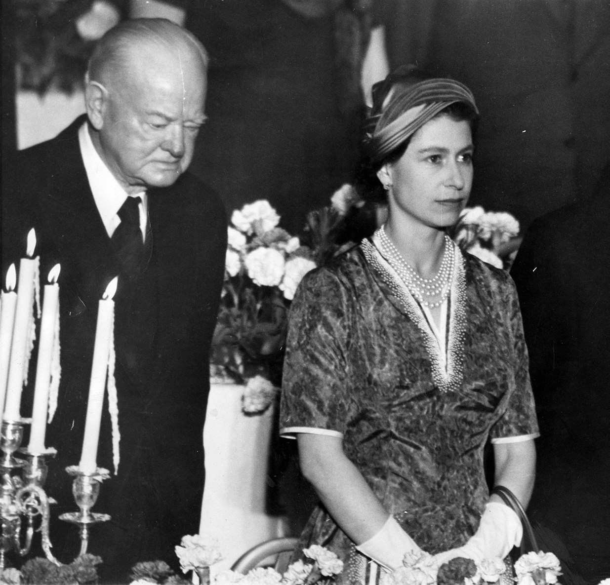 Photo of Queen Elizabeth II with former President Hoover and New York City Mayor Robert Wagner at a luncheon.