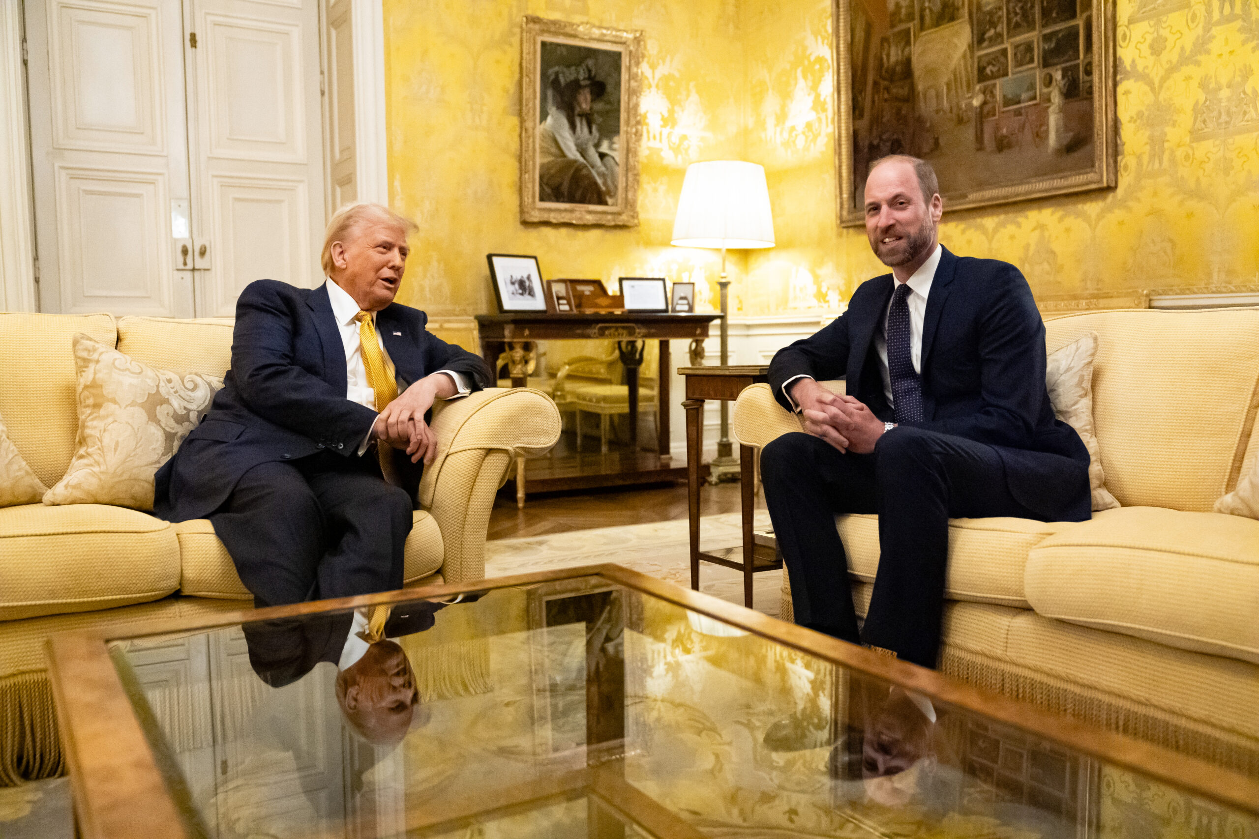 Donald Trump and Prince William sitting on sofas in a room at the UK Ambassador's Residence in Paris.