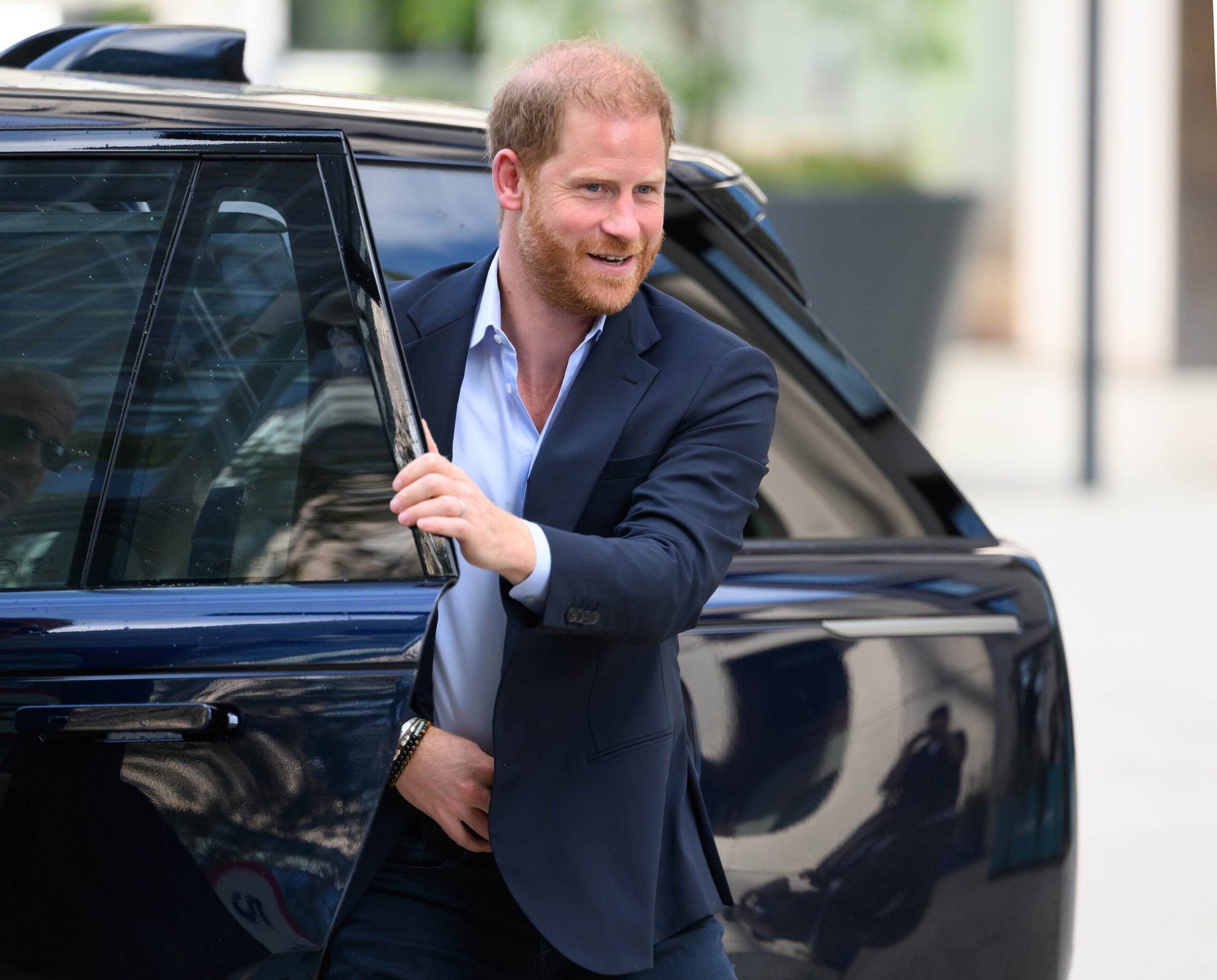 Prince Harry exiting a car.
