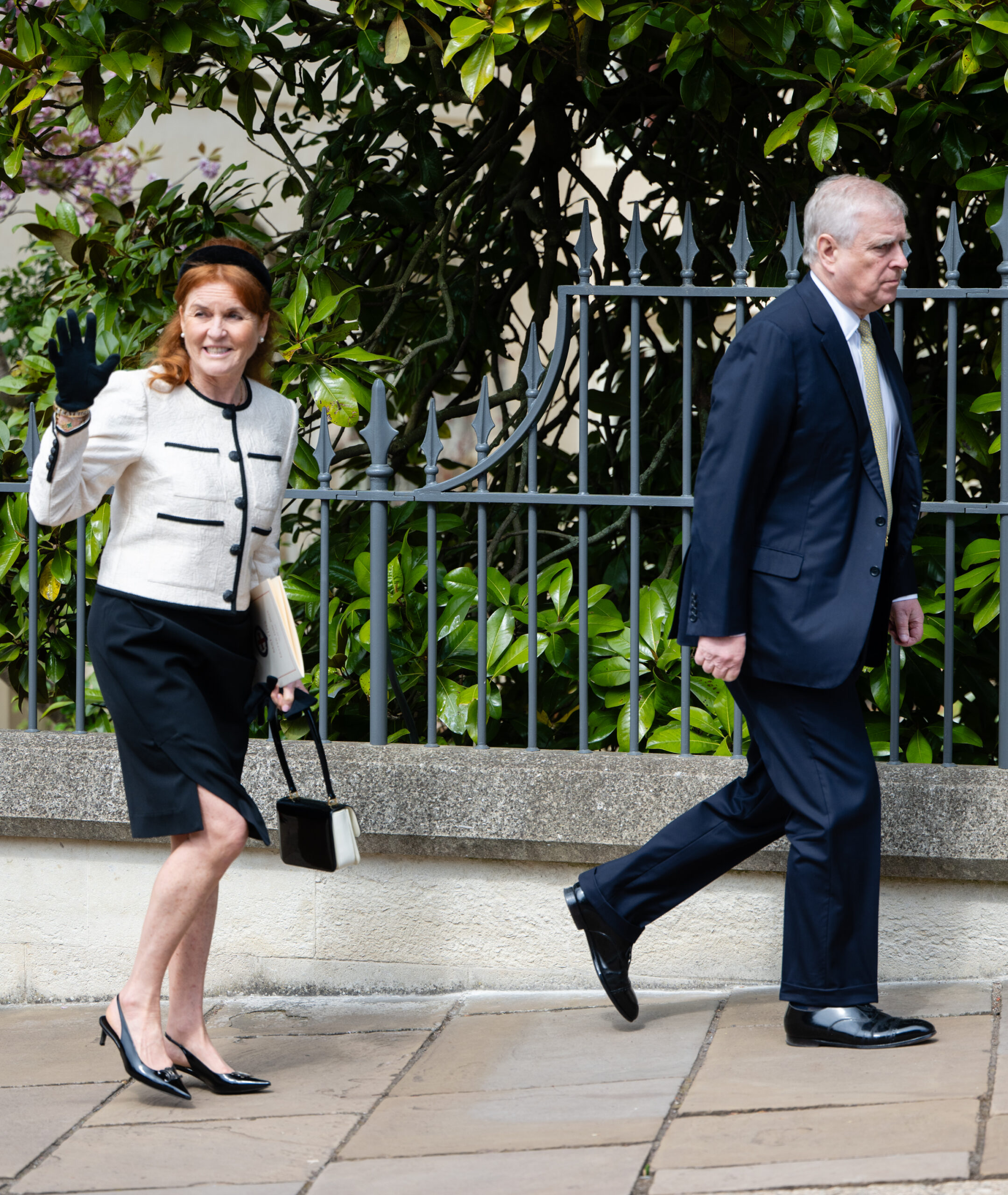 Sarah Ferguson waves while walking with Prince Andrew after attending Easter Sunday service