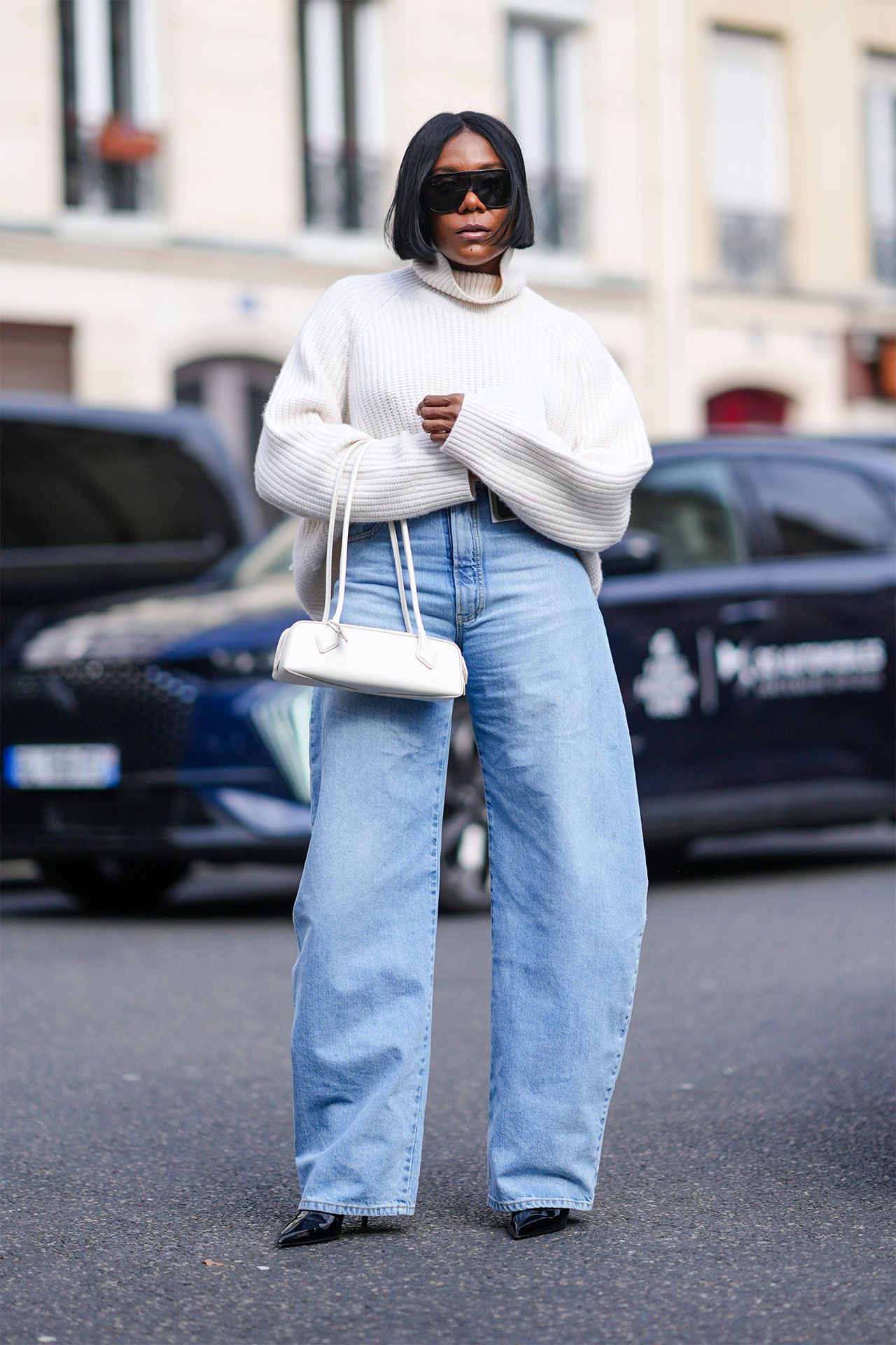 Image may contain Clothing Jeans Pants Adult Person Accessories Bag Handbag Knitwear Sweater Footwear and Shoe