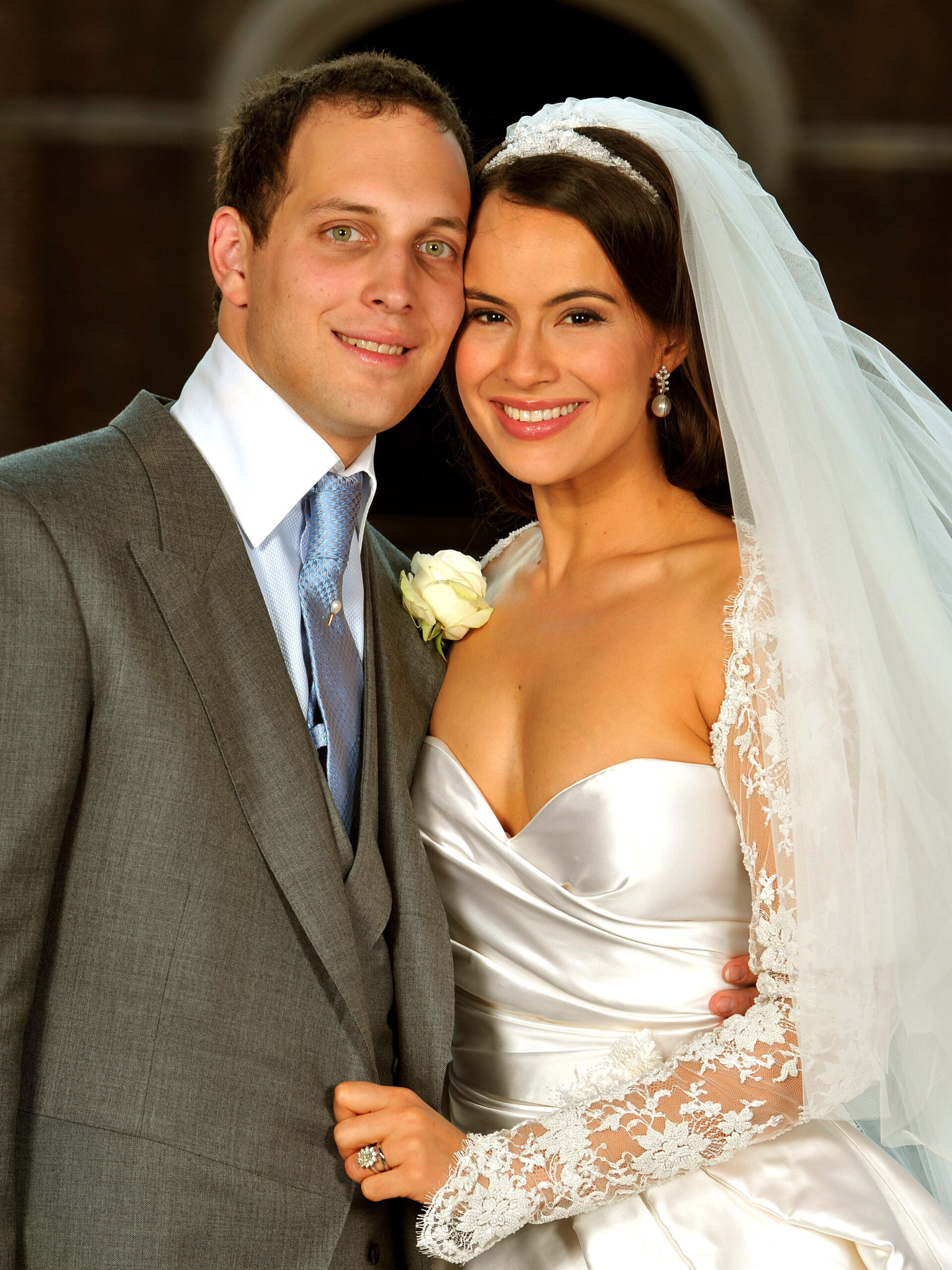 Sophie Winkleman and Frederick Windsor smiling and touching cheeks together at their wedding