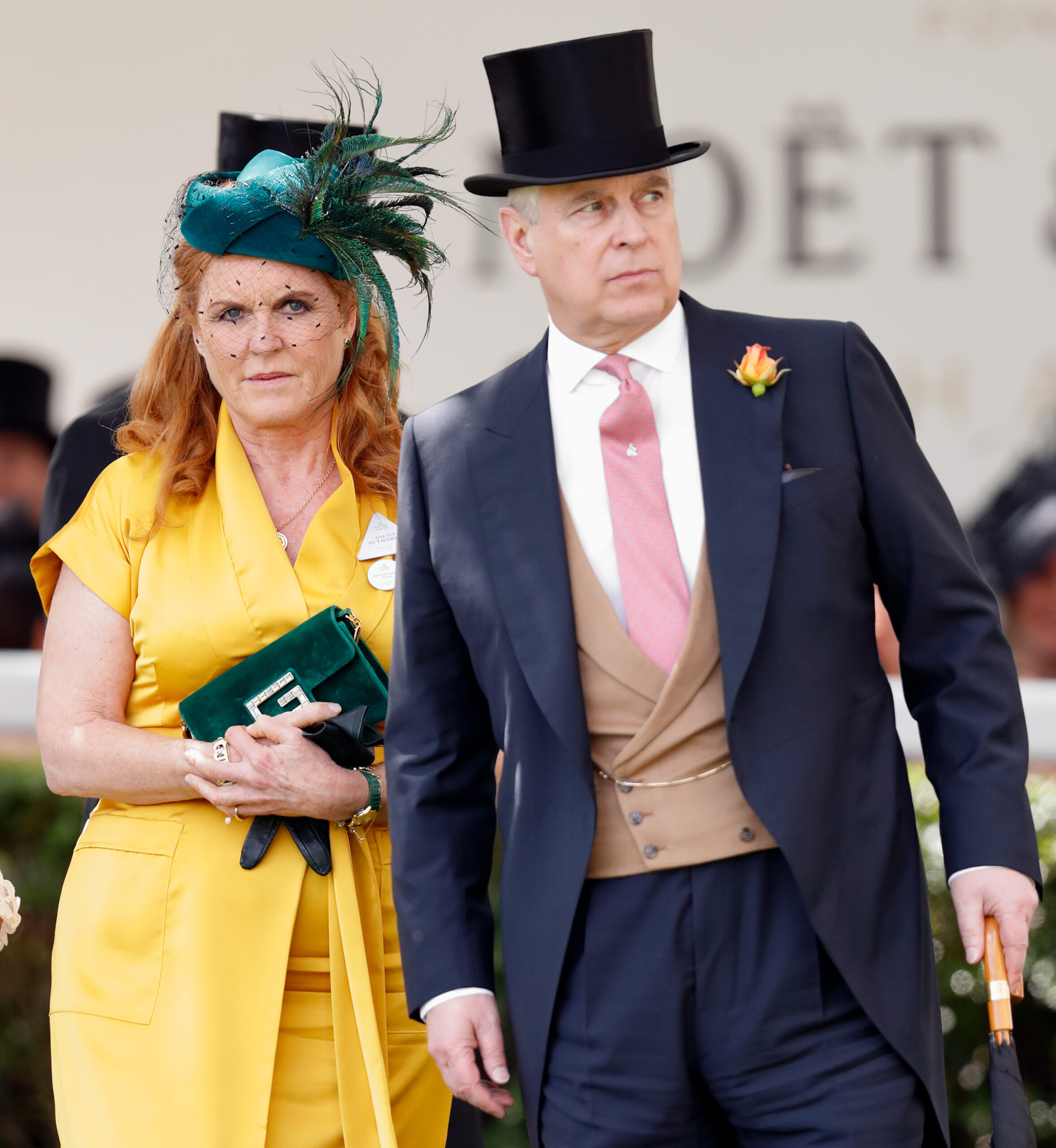 Sarah Ferguson, Duchess of York, in a yellow dress and a green fascinator, next to Prince Andrew, Duke of York, in a black top hat and tailcoat.