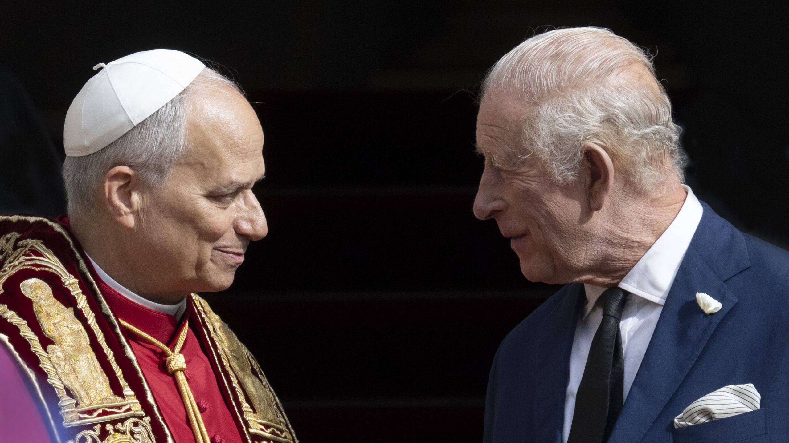 Pope Leo XIV and King Charles III looking at each other.