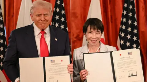 Getty Images Japan's Prime Minister Sanae Takaichi (R) and US President Donald Trump attend a signing ceremony after a Japan-US Summit at the Akasaka State Guest House in Tokyo on October 28, 2025.