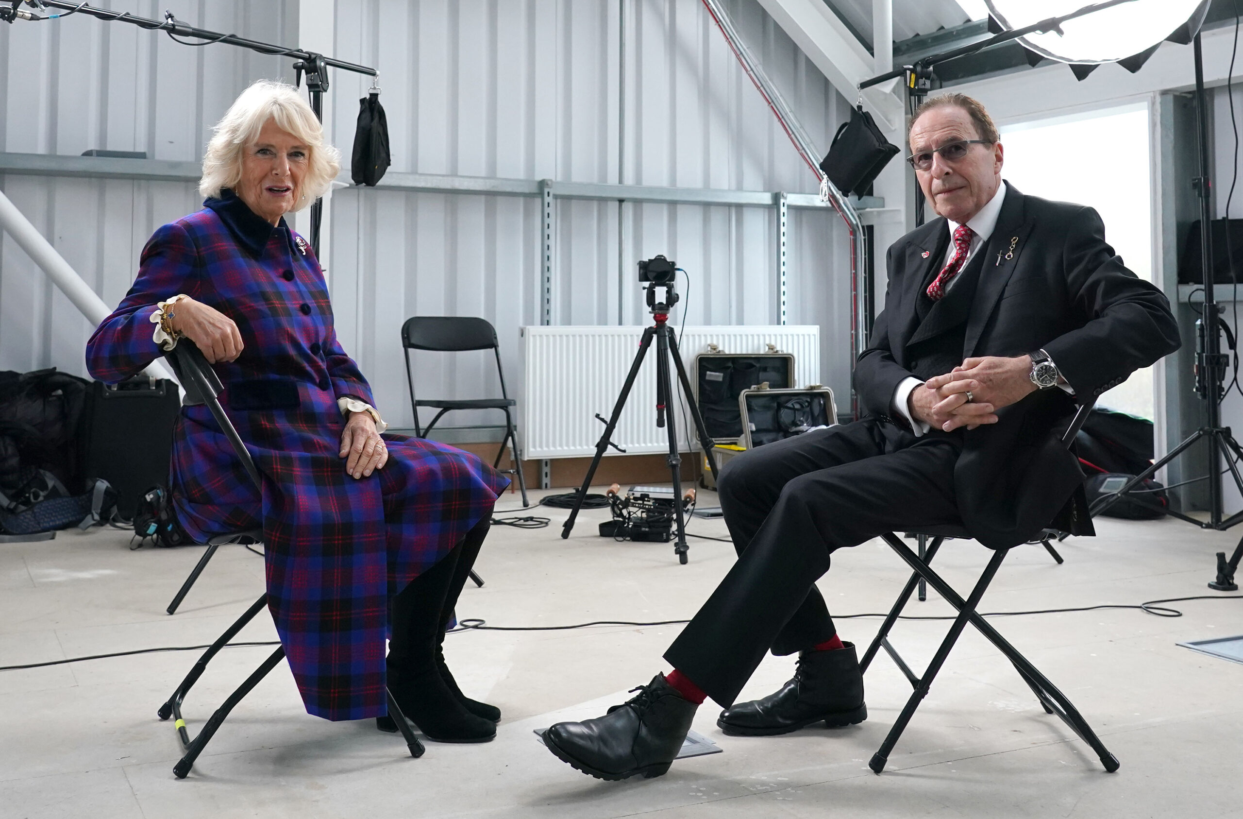 BRIGHTON, ENGLAND - NOVEMBER 04: Camilla, Duchess of Cornwall speaks with author Peter James during her visit to the set of ITV's Adaptation Of The Roy Grace Series By Peter James on November 4, 2021 in Brighton, England. (Photo by Gareth Fuller - WPA Pool/Getty Images)