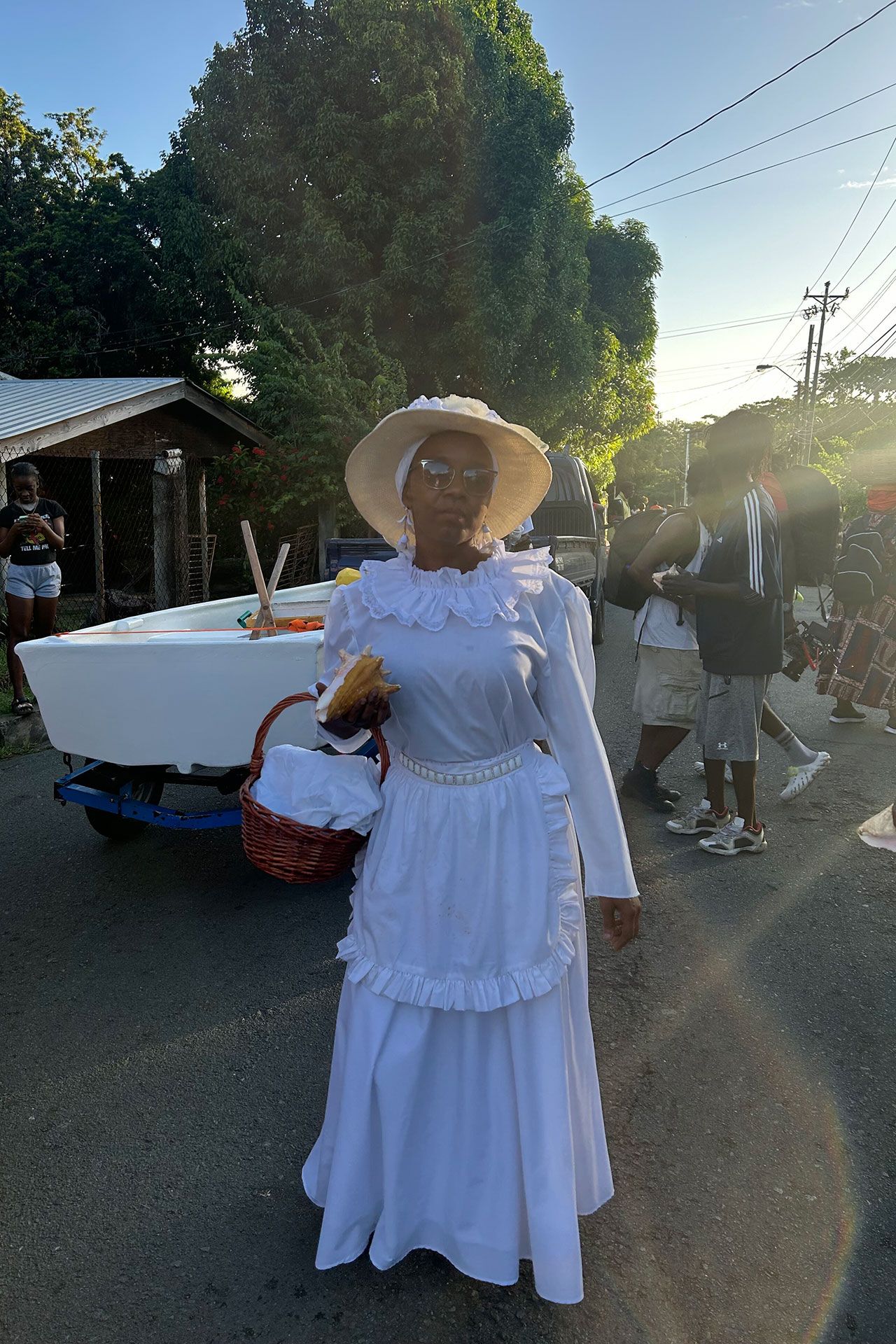 The woman in white pays tribute to the community's ancestors