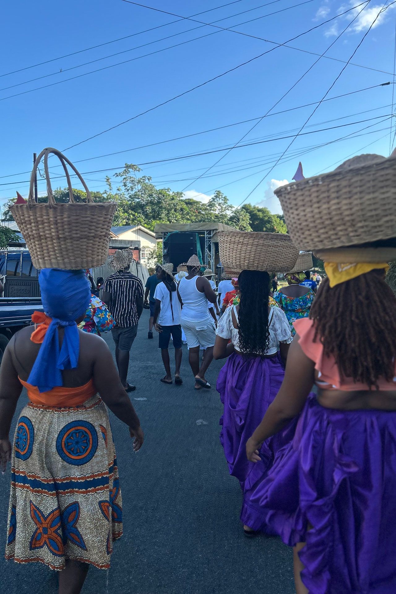 Women in colourful headwraps march together