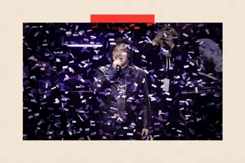 EPA/Shutterstock Javier Milei speaks during an event with confetti surrounding him