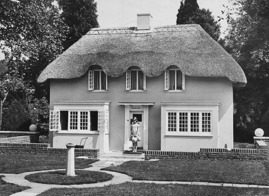 Princess Elizabeth stands in the doorway of Y Bwthyn Bach, situated in the grounds of the Royal Lodge, in June 1933. The cottage was a gift from the people of Wales.