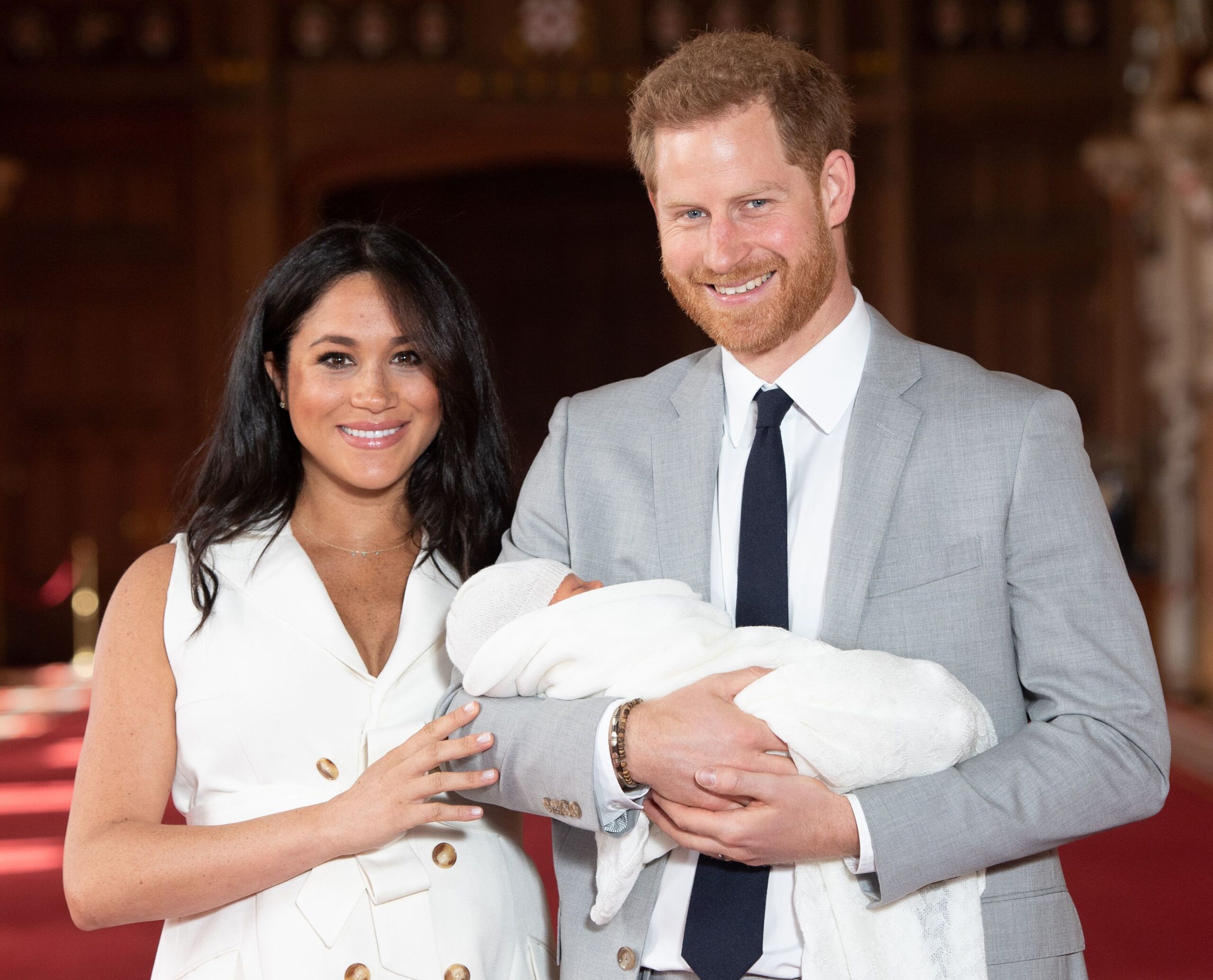 The Duke and Duchess of Sussex smiling and posing with their newborn son, Archie.