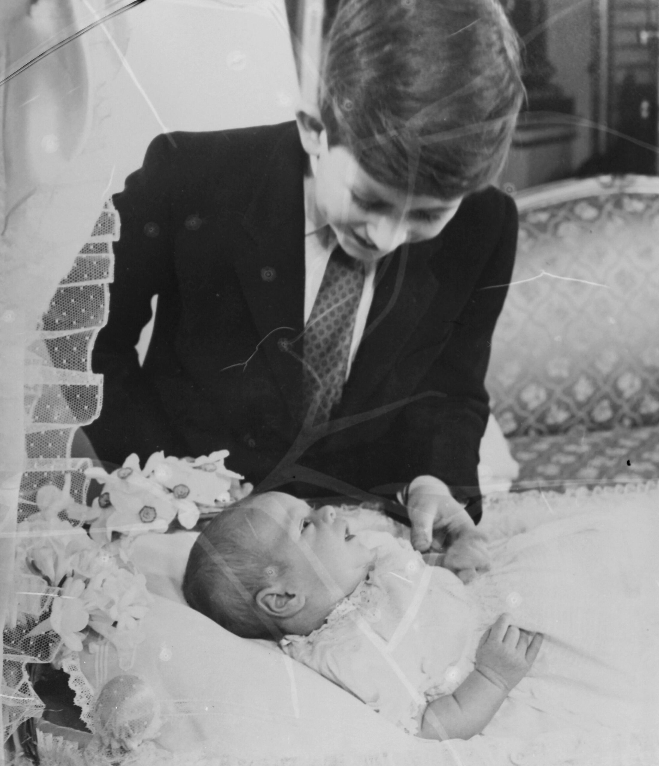 Prince Charles looking at baby brother Prince Andrew.