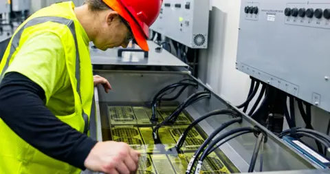 Getty Images A technician working on an immersion cooling system in a data center for cryptocurrency mining, cloud services and AI computing