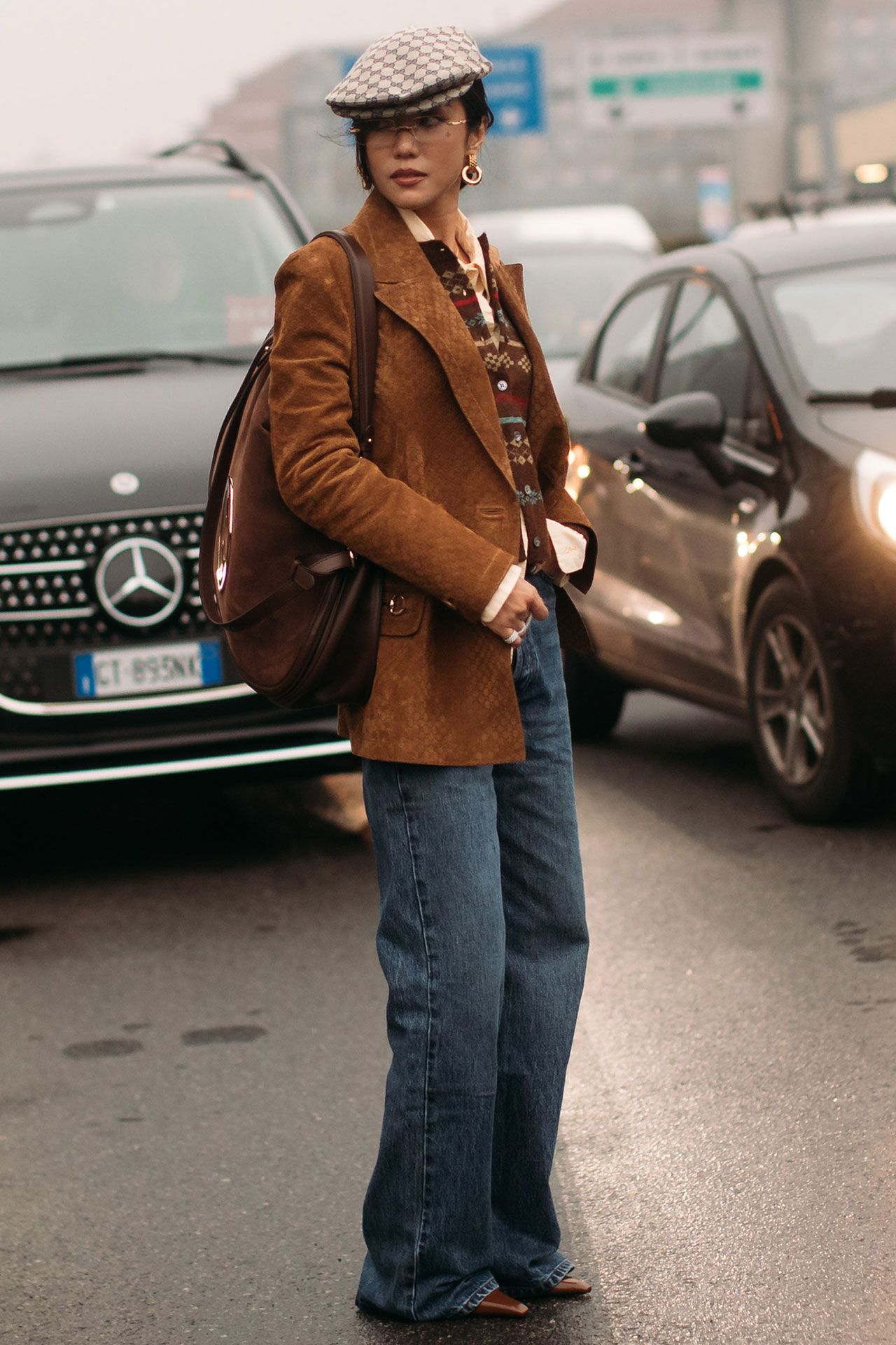 Image may contain Clothing Pants Coat Jacket Blazer Jeans Adult Person Accessories Bag Handbag and Car