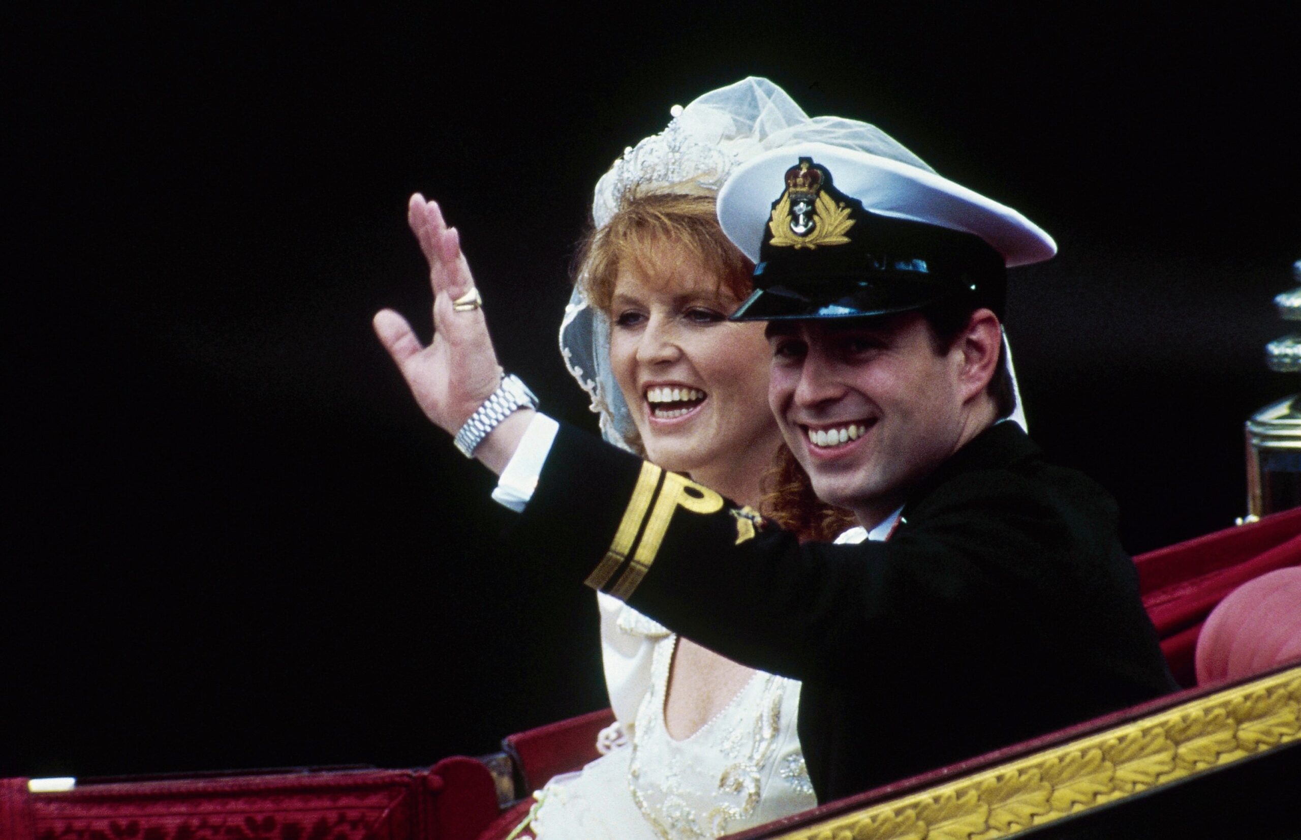 Andrew, with his bride, Sarah, waves from their horse-drawn carriage as they leave Westminster Abbey following their marriage in London, July 23, 1986