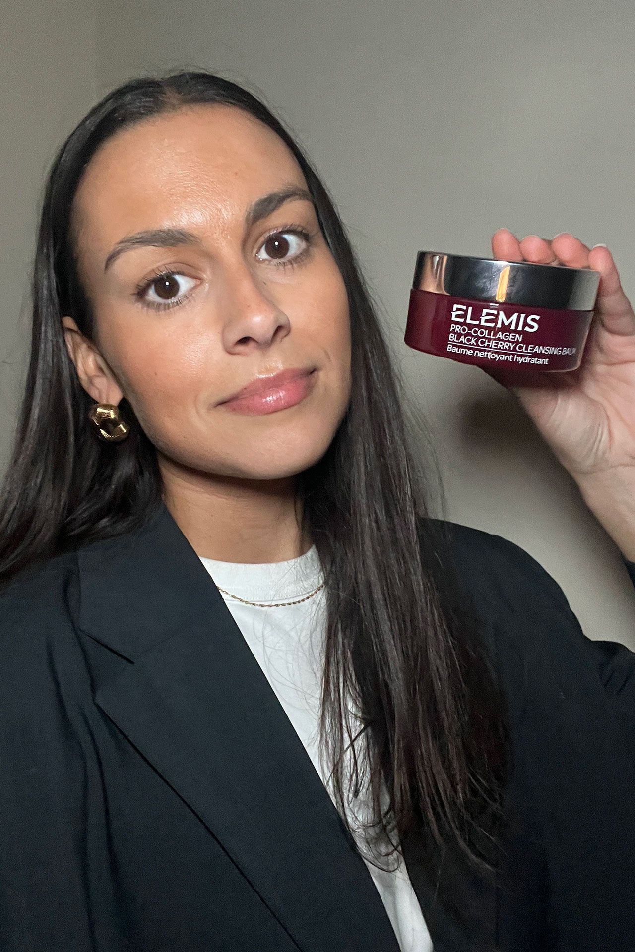 Image may contain Sophia Latjuba Face Head Person Adult Photography Portrait Clothing Coat Black Hair and Hair