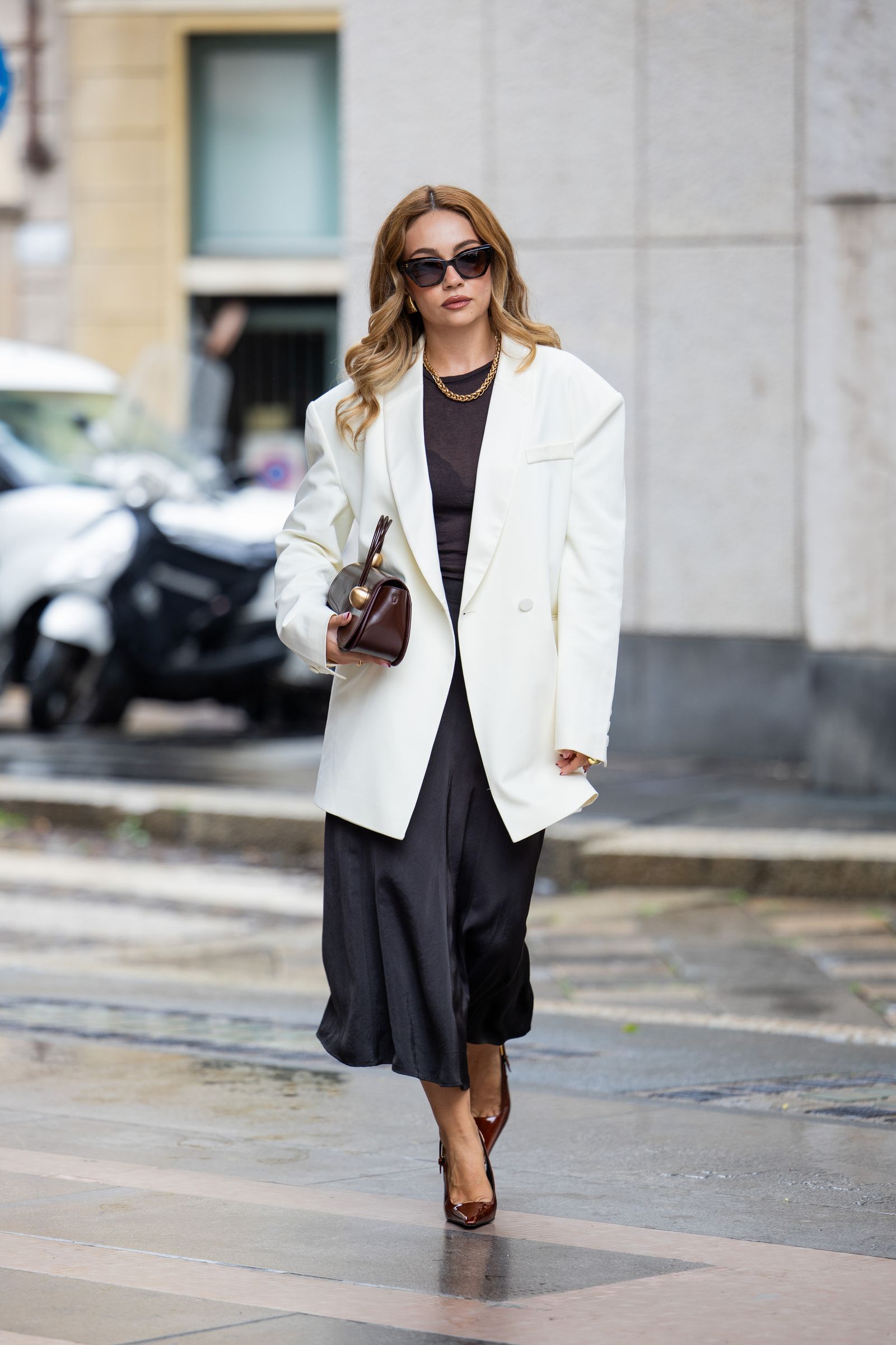 Image may contain Clothing Coat Blazer Jacket Adult Person Formal Wear Suit Footwear Shoe Accessories and Glasses