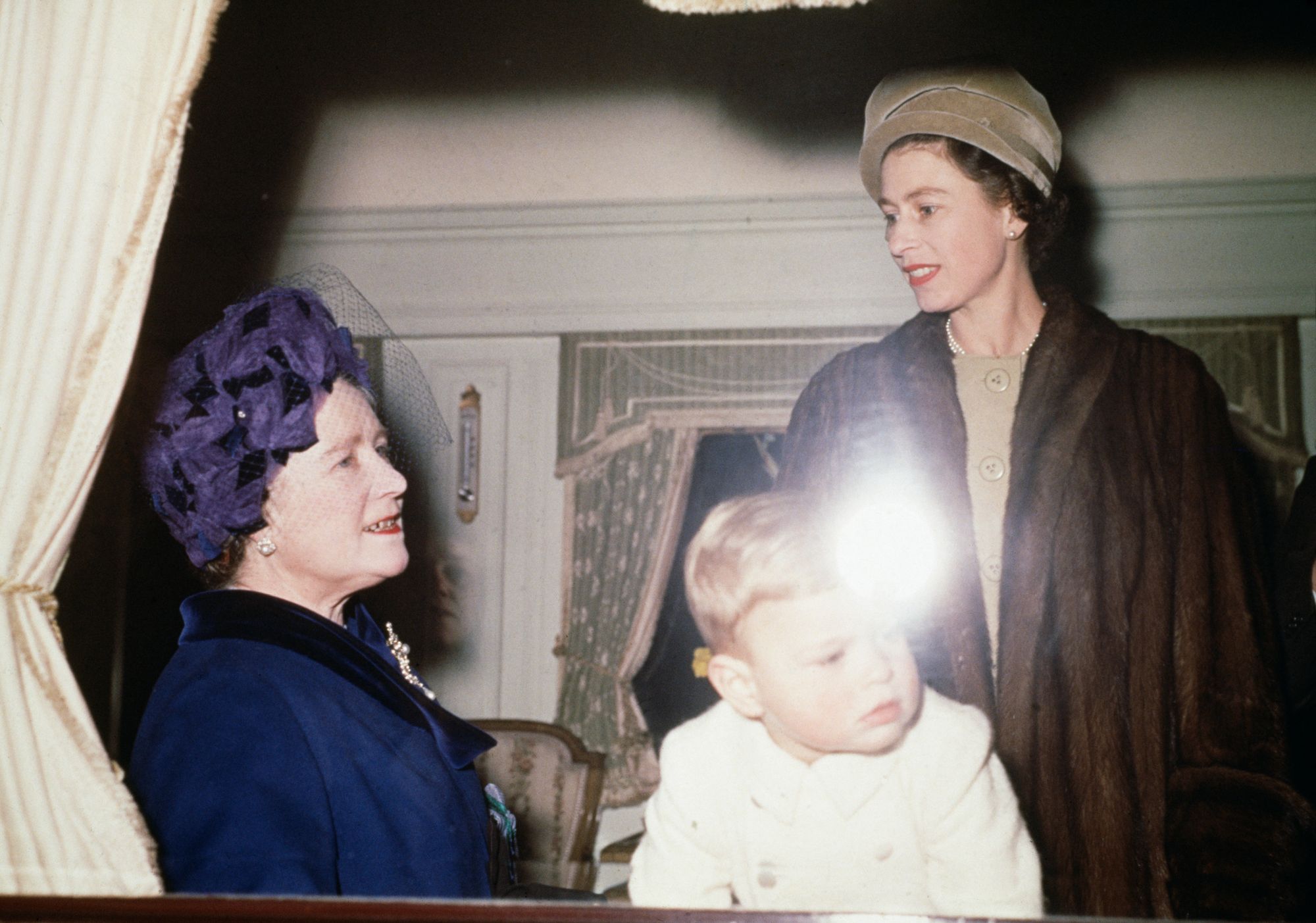 Prince Andrew and Queen Elizabeth II aboard the royal train en route to Sandringham House in Norfolk for Christmas, on 21 December 1961. (Photo by Fox Photos/Hulton Archive/Getty Images)