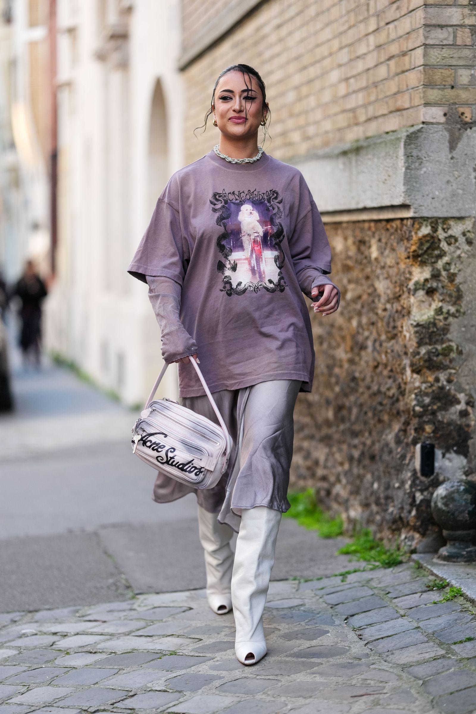 Image may contain Pedestrian Person Clothing Pants Accessories Bag Handbag Adult Glove Jewelry and Necklace