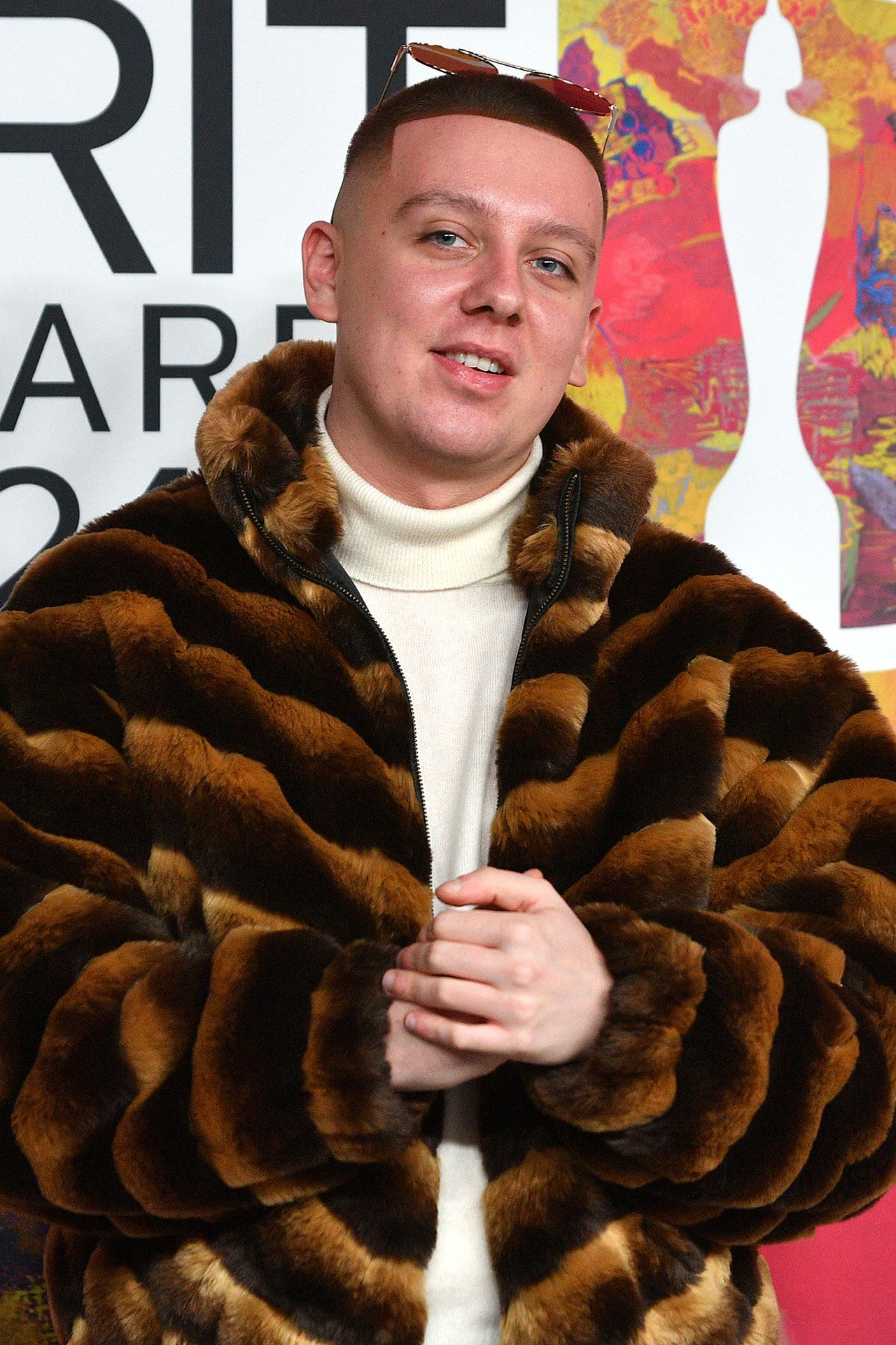 Image may contain Clothing Coat Face Head Person Photography Portrait Adult Fur and Jacket