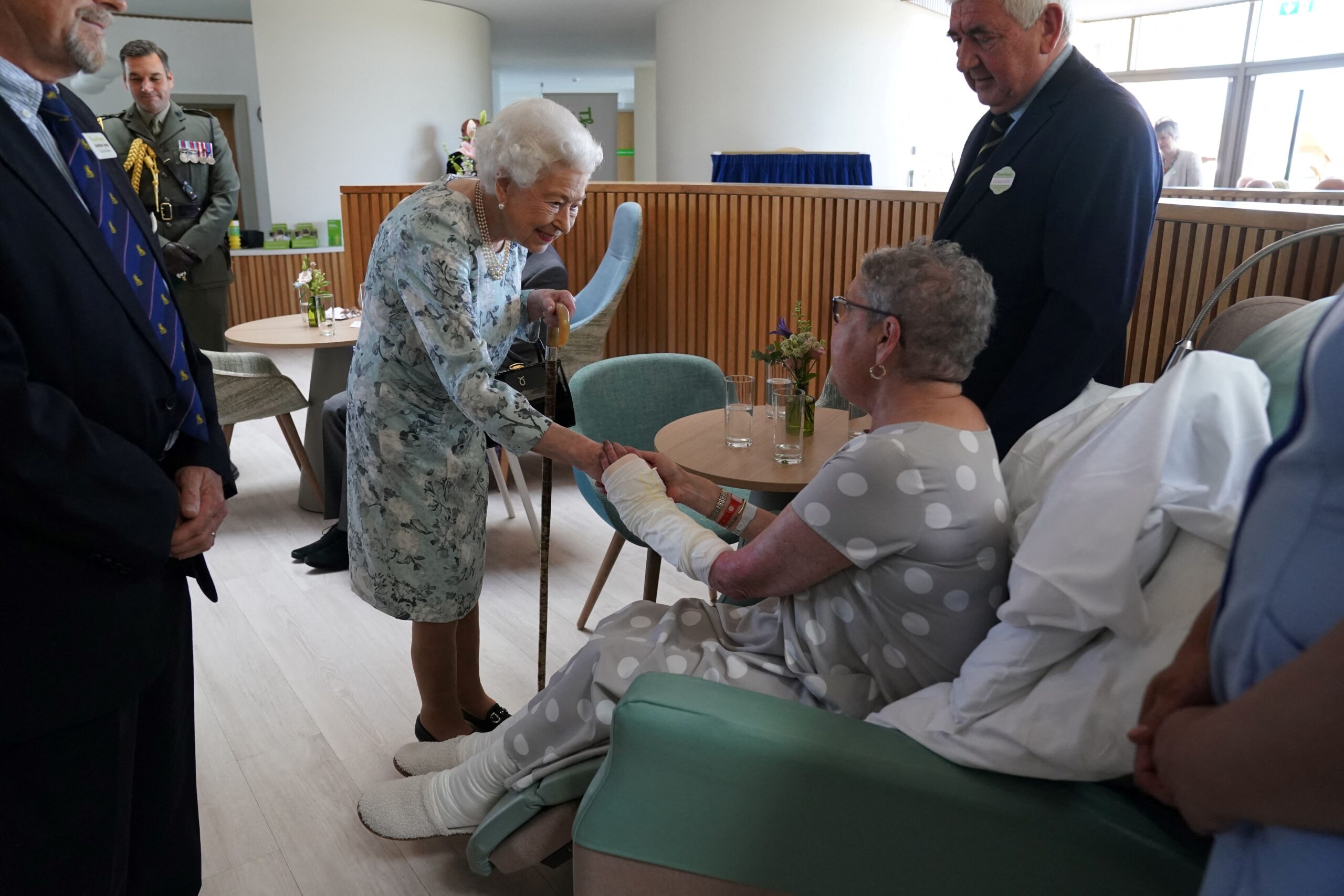 Queen Elizabeth shaking hands with a hospice patient