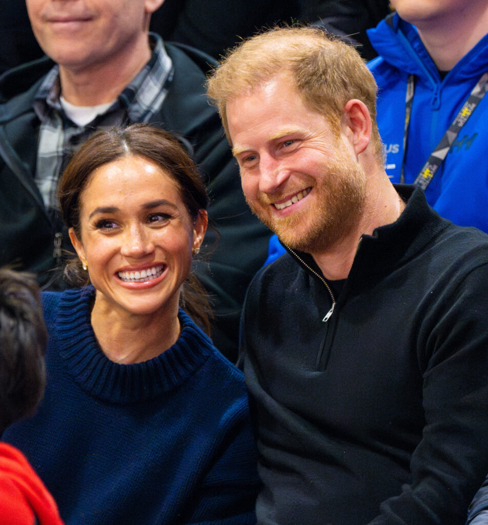 Prince Harry and Meghan grinning