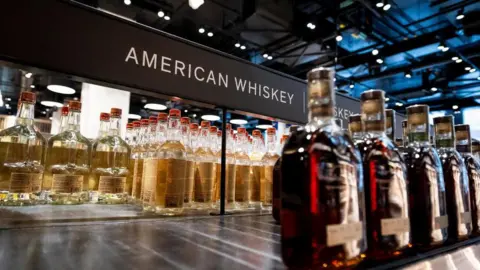 Getty Images An empty shelf at an Ontario liquor store under the sign 'American Whiskey'. 