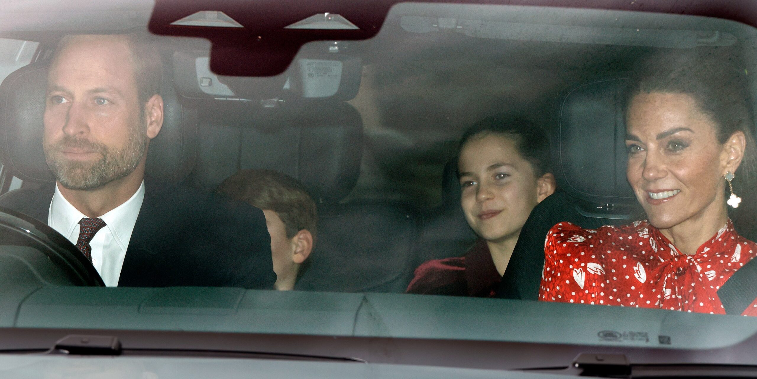 Prince William, Princess Charlotte, and Catherine, Princess of Wales, in a car arriving at Buckingham Palace.