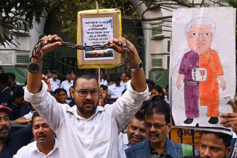 Getty Images Members of the BLO Adhikar Raksha Committee took out the procession from College Square to Election Commission Office to protest against Special Intensive Revision (SIR) process claiming tremendous stress and workload on November 24, 2025 in Kolkata, India.